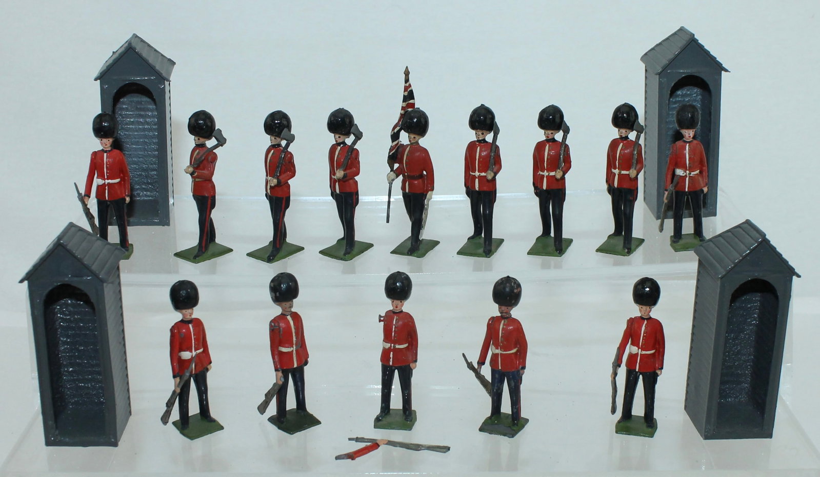 Britains Lot Guards and Sentrys: Lot includes Officer with Flag and Pioneers with Axes From 82 Scots Guards Color and Pioneers and 4 Sentry Boxes and 7 Sentrys From 329 Sentry Box with Sentry. 18 Pieces. Condition Good to Very Good. 