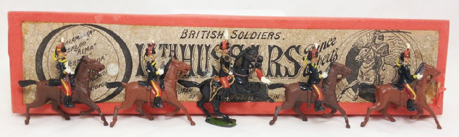Britains Set #12 The 11th Hussars: With original partitioned box. Extremely rare 1st version. Donkey horse with short carbines. Officer with tin sword on rearing Germanic horse with throat plume. Circa 1895. 5 Pieces. Condition: Excell