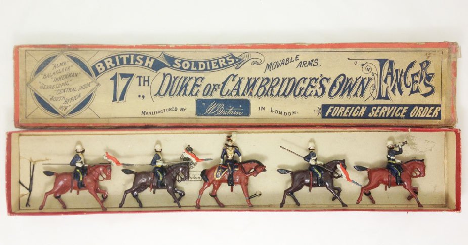 Britains Set #81 17th Duke of Cambridge’s Own: 17th Duke of Cambridge’s Own Lancers tied in original box. Circa 1899. Pony horse with Ulundi helmets and Officer cross-saddle with drawn sword. 5 Pieces. Condition: Figures- Excellent, Box- Very Go