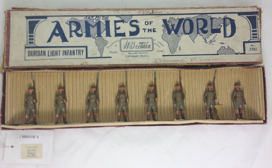 Britains Set #1293 Durban Light Infantry: In Original Armies of the World box with slotted tie card. With Officer marching at the slope in shorts. Pre War. 8 Pieces. Condition: Figures- Excellent, Box- Very Good, with heavily worn edges.