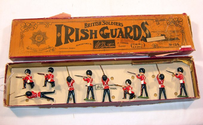 Britains: 10 Grenadier Guards Firing: Guards Firing in Three Positions. 3 kneeling, 3 standingfiring, 4 lying firing 1950’s in wrong Irish Guard “Whisstock” box #124; wrong tie card (NM, box P) (10).