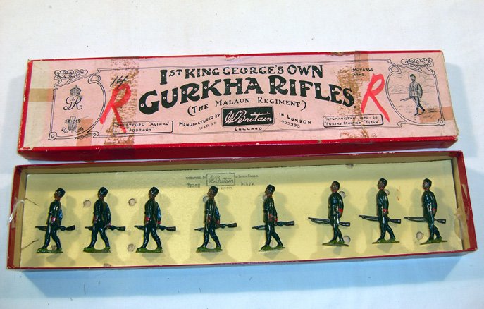 Britains: Set #197 1st King George’s Own: Gurkha Rifles, The Malaun Regiment 1925-1941. 8 marching at the trail, pillbox caps loose in original “Whisstock Flowers” box (NM, Box F, some scotch tape and marks) [8]. Wrong tie card.