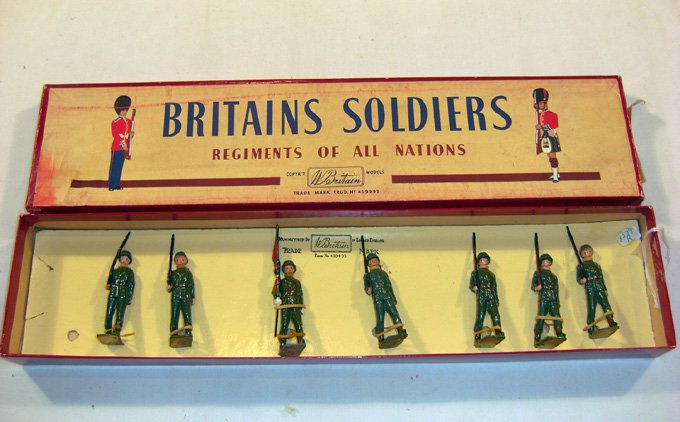 Britains: Set # 2104 Venezuelan Infantry: Post-War. Set 6 infantry and 1 flag bearer in original “Regiments” box (NM, box G) [7]. Home-made label, wrong tie card, mismatched.