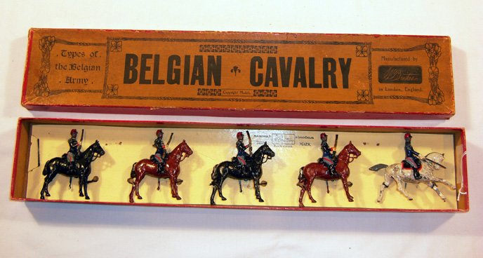Britains: Rare Early Set # 190 Belgian Cavalry: Circa 1920-1930. 4 troopers with rifles, 1 office on grey horse with sword drawn, in original “Flowers” box, retied. (VG+, age chips, box F) [5].