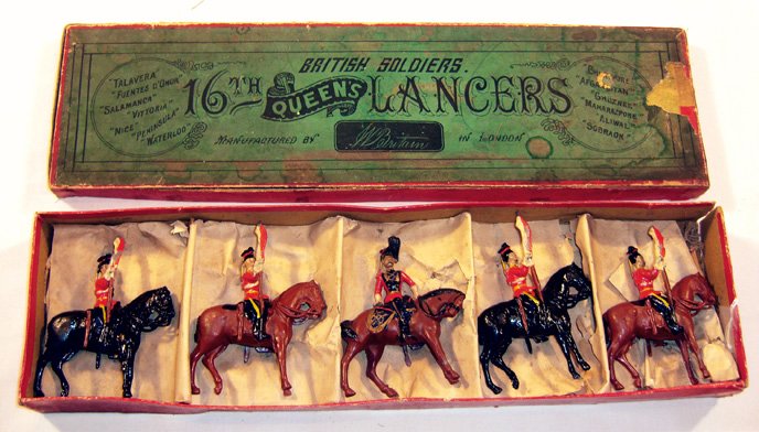 Britains: Rare Early Set # 33 16th/5th Lancers: Mounted at attention, with 1 officer, red tunics, with yellow belts, collars and stripes on dark blue trousers, black plumes on lancer caps, lances held at the carry, officer turned in saddle, in orig