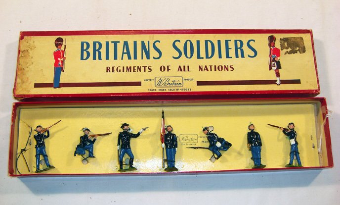 Britains: Set # 2059 Union Infantry: Post War Set. Comprising, 2 standing firing, 2 kneeling firing, 1 bugler, 1 flag bearer, and 1 officer with pistol tied in original “Regiments” box (M, box F marks) [7].