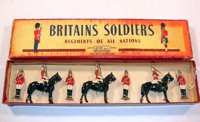 Britains: Set # 2029 The Life Guards: Mounted and Foot. Post War Set in “Regiments” box 4 dismounted, 3 mounted at the halt with swords in original “Regiments” box (NM, chips, box P) (7). Replacement card.