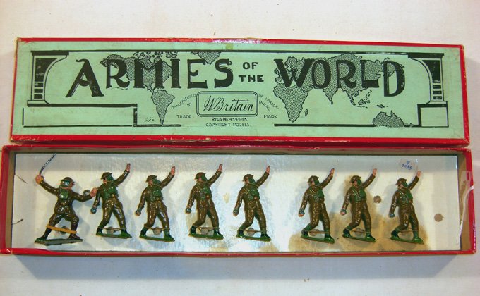 Britains: Set # 1612 British Infantry: In Action. 7 bomb throwing with gas mask, in original “Armies” box, 1 officer (NM, few chips, box G) (8). Replacement card.