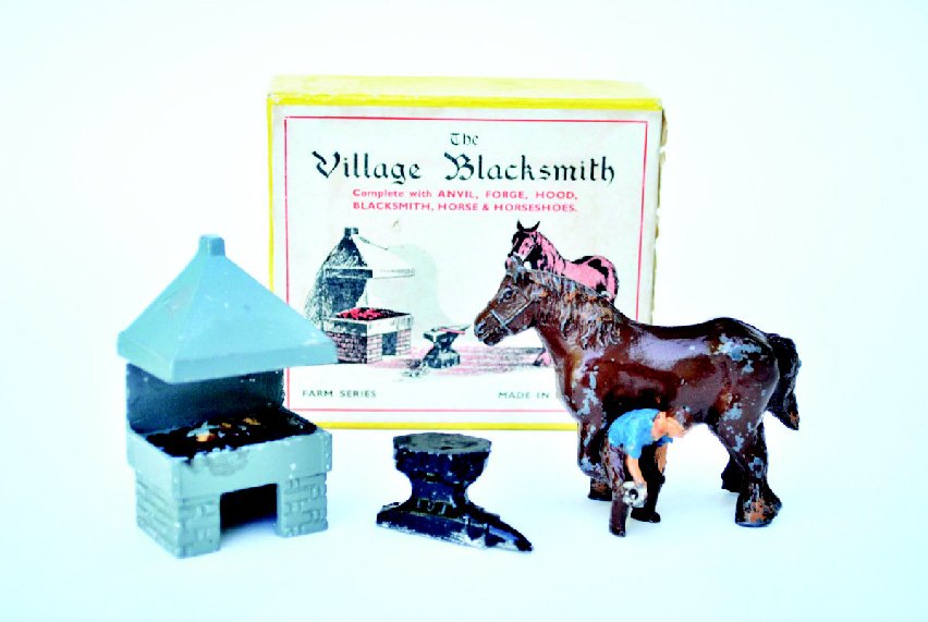 F.G. Taylor & Son Blacksmith Set: Post War with Original Box Comprising of Black Smith, Forge, Anvil and Horse. 4 Pieces. Condition Very Good, Box Very Good.