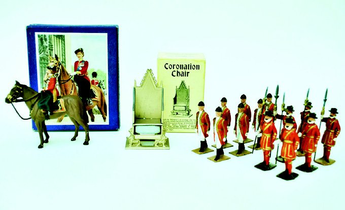 Britains and Timpo Coronation Items: Coronation Throne and Stagecoach Attendents with Beefeaters. And a Timpo Boxed HM the Queen. 15 Pieces. Unboxed. Condition Very Good.