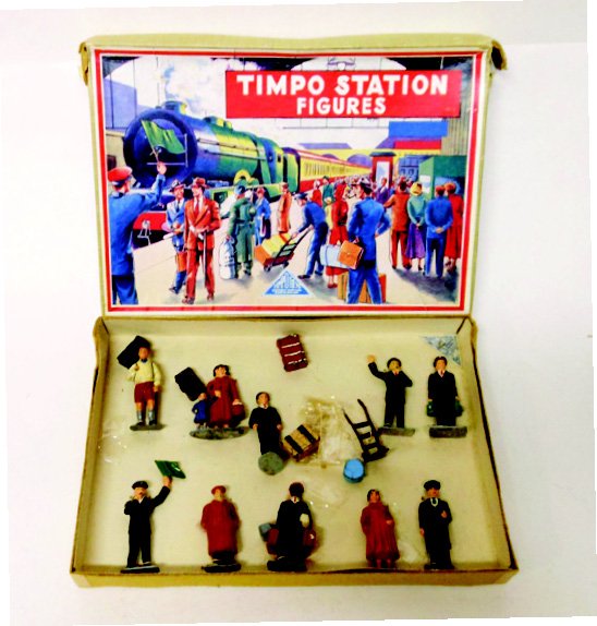 Timpo Railway Display Set #830: Post War. Tied in Original Illustrated Box (box is Good, lid is split in 2 corners). 16 Pieces including Luggage. With RARE Red Cap Porter as Issued for the U.S. Market Only. Condition Excellent (lugg