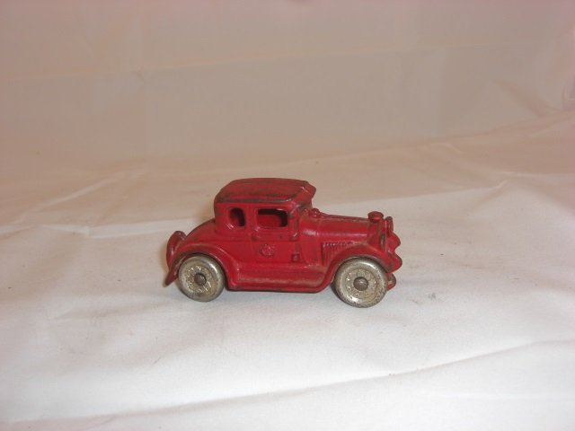 Cast Iron Sedan: With Silver Metal Wheels. 3 1/2 Inches long. 1 Piece. Condition Very Good.