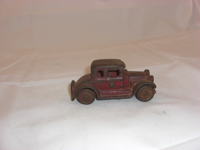 A. C. Williams Cast Iron Sedan: With Cast Wheels. 3 1/2 Inches long. 1 Piece. Condition Good.