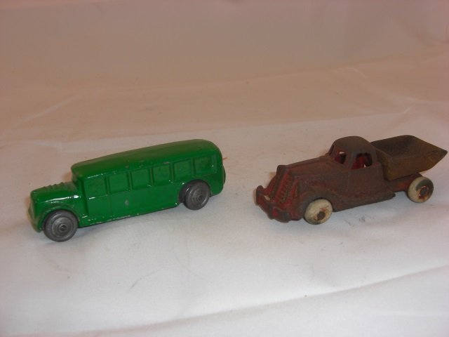Cast Iron Dump Truck & Bus: Bus Repainted. Includes 3 1/2 Inch long Truck and 3 1/2 Inch long Bus. 2 Pieces. Condition Good; Truck is rusted.