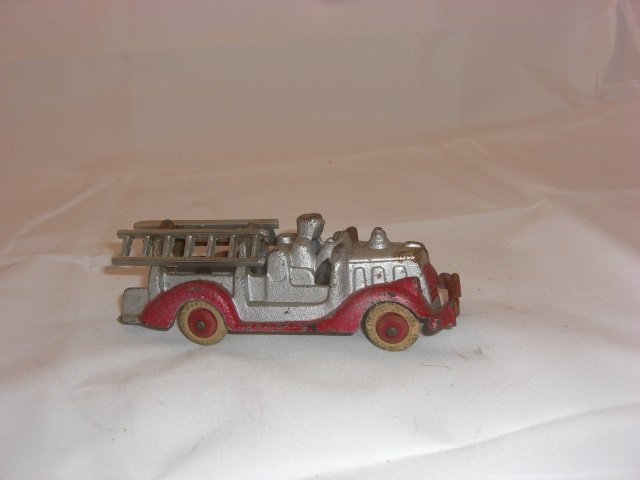 Cast Iron Fire Truck: With Rubber Wheels. Ladders Detach. 5 Inches long. 1 Piece. Condition Very Good.
