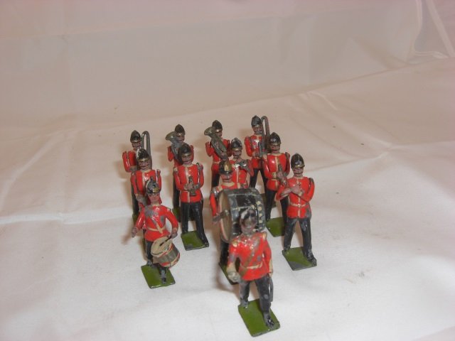 Britains From Set #27 Band of Line: Pre War. Includes Half Booted Drummers and Drum Major. 12 Pieces. Condition Good; Drum Major head damaged and missing baton. 9 Helmet spikes missing. Drummer missing side drumstick with chips.