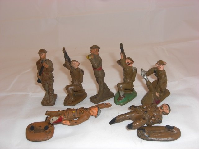 Auburn Rubber Military Figures: Includes A2 Private Infantry, A4 Infantry Bugler, 2A29 Plane Shooter and A32 Trench Mortar. 7 Pieces. Condition Excellent; 2 broken and Bugle tip damaged.