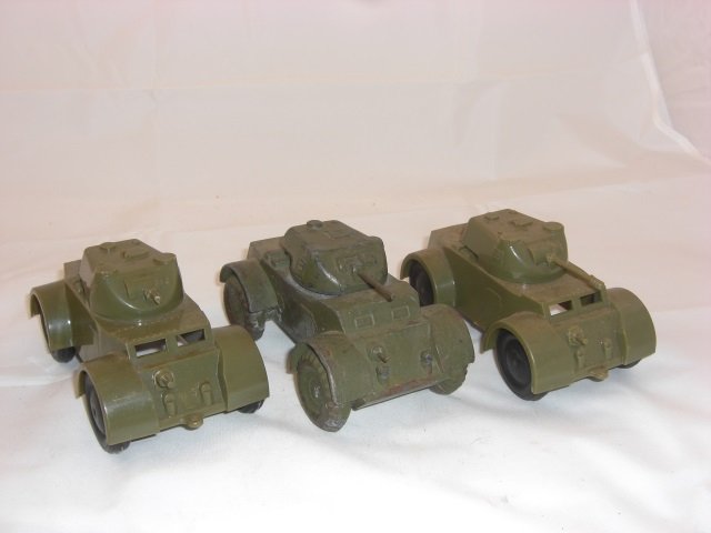 Armored Cars: 5 1/2 Inches long. Fixed wheels. 2 Processed Plastic and 1 Solid Metal. Painted Brassie. 3 Pieces. Condition Very Good; 1 broken gun.