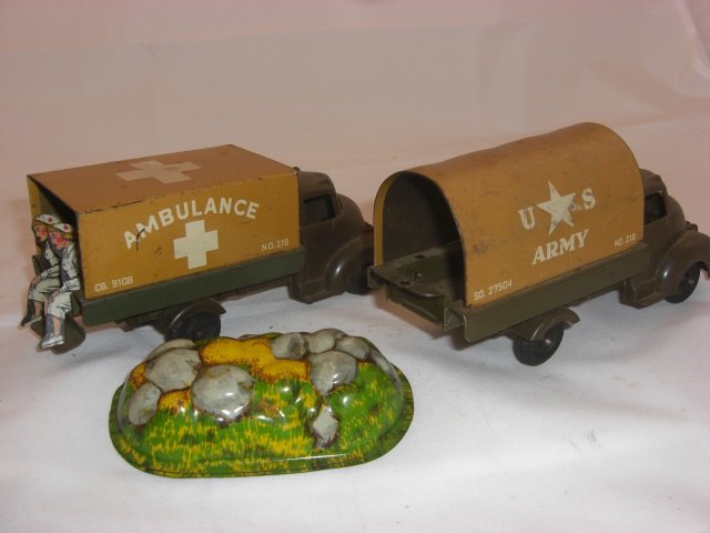 Banner Trucks: 4 Inches long with Plastic Cabs and Metal Canopies. 1 Metal Terrain Piece. 3 Pieces. Condition Very Good.