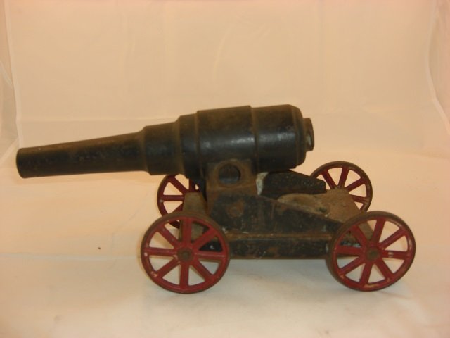 Connestoga Big Bang Cast Iron Cannon: 14 Inches long and 6 Inches High with Metal Wheels. Gun Barrel Pivots Up & Down. 1 Piece. Condition Very Good.
