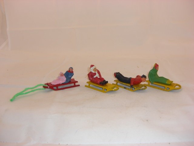 Barclay Sled Riders: Includes B194 Santa on Sled, B193 Girl on Sled, B192 Man on Sled, and B199 Children on Sled. 4 Pieces. Condition Excellent; Sleds have few chips.