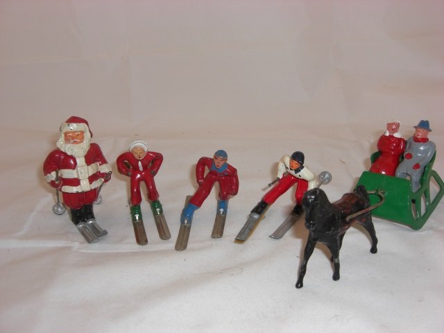 Barclay Skiers & Sleigh: Includes B197 Santa on Skis, 2 B190 Man on Skis, B191 Girl on Skis and B198 One Horse Open Sleigh with Man, Woman and Horse. 5 Pieces. Condition Excellent; 1 Skier with loose skis.