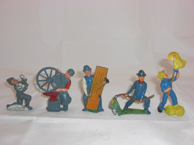 Manoil Civilians: M168 Boy Carrying Wood, M150 Blacksmith with Wheel, M151 Carpenter Carrying Door, M136 Farmer Cutting with Scythe and M133 Farmer Pitching Sheaves. 5 Pieces. Condition Excellent.