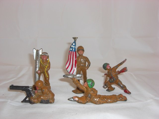 Manoil Soldiers: M191 Aviator Holding Bomb, M197 Sitting Machine Gunner, M177 Flag Bearer, M184 with Shell for Bazooka and M201 Throwing Hand Grenade. 5 Pieces. Condition Very Good.