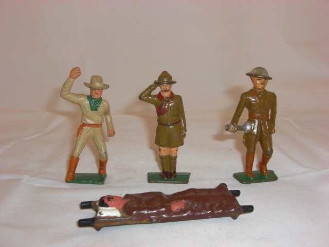 Grey Iron Figures: G55 Cowboy with Lasso, G72 Boy Scout Saluting, G82 Legion Bugler, and G90 Stretcher with Patient. 4 Pieces. Condition Excellent.