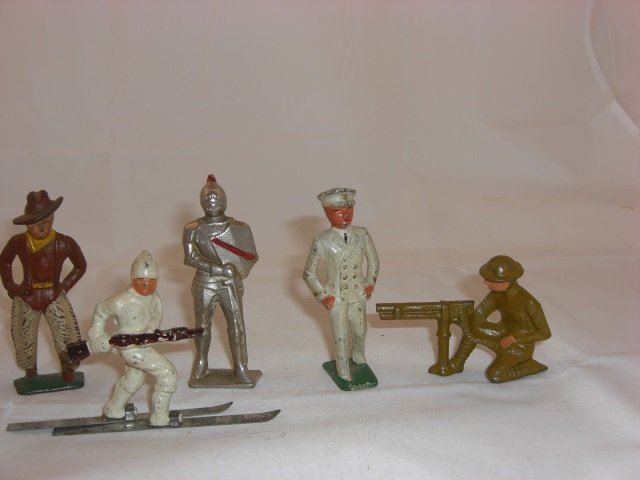 Grey Iron Figures: G93 Knight in Armor, G108 Foreign Legion Officer, G55 Cowboy with Lasso, G96 Stretcher with Patient, and G61 US Machine Gunner. 5 Pieces. Condition Excellent.