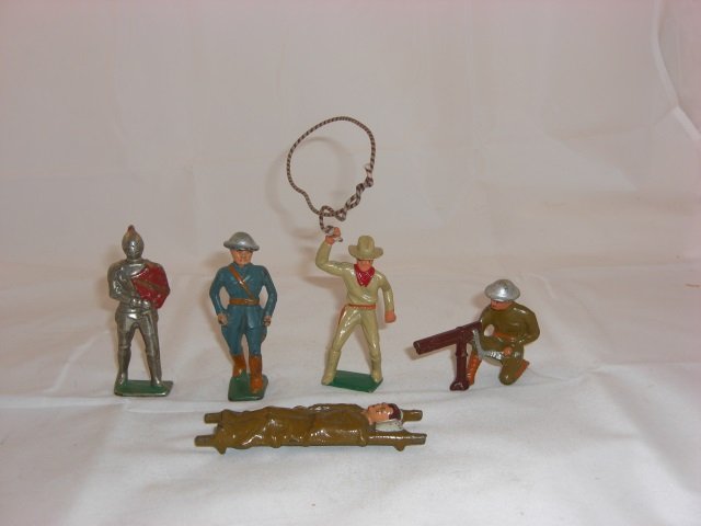 Grey Iron Figures: G53 Cowboy, G93 Knight in Armor, G70 US Naval Officer in White, G61 US Machine Gunner, and G101 Ski Soldier S533. 5 Pieces. Condition Excellent.