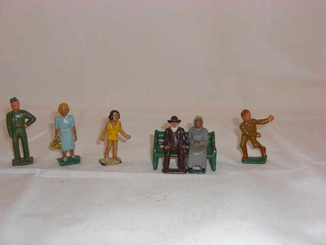 Grey Iron Pieces: H2 Woman with Basket, H3 Boy Flying Kite, H5 Old Man Sitting, H6 Old Woman Sitting, H9 Garageman, H13 Lawn Seat and B9 Girl Catching Ball. 7 Pieces. Condition Excellent.