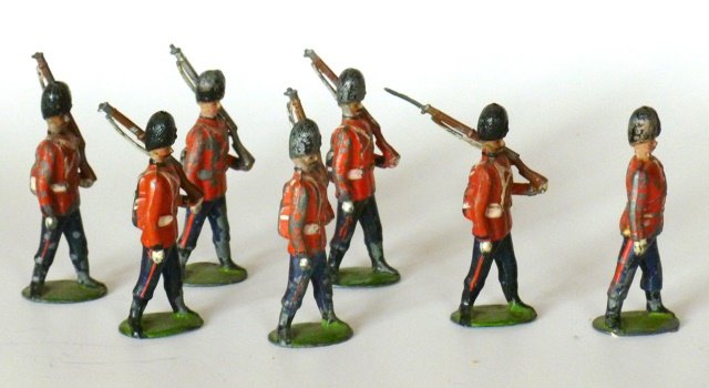 Britains Set #7 Seventh Royal Fusiliers: RARE Valise packs, circa 1897. Oval Based. 7 pieces. Unboxed. Condition good/fair. (5 Bayonets missing.)