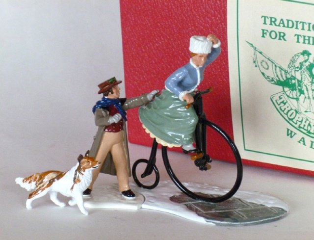 Trophy Miniatures Christmas Series: 3 pieces. Steady as she goes. Lady riding penny farthing bicycle, with supporting gentleman. With original box. Condition Excellent. Box Excellent.