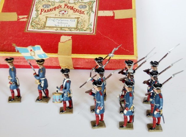 Mignot Louis XIV Infantry: Blue Uniforms. Post War. 12 pieces with original box. Untied. Condition excellent. Box Good, (tape on box).