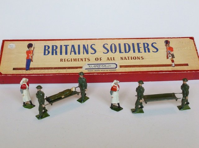 Britains Set #1723 Royal Army Medical Corp: Stretcher Unit. Post War. 9 pieces. With original Regiment of All Nations box. Condition excellent. Box very good. (writing on label, two stickers on label)