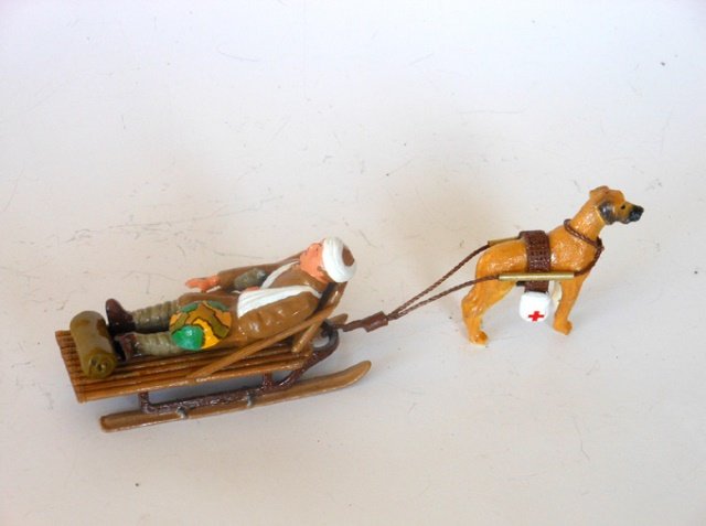 Lou Steinberg’s Unique Conversion Dimestores: Wounded soldier on hand crafted wooden chaise, mounted on top of sled. Medical dog to pull sled. Circa 2003. Condition excellent. Unboxed.
