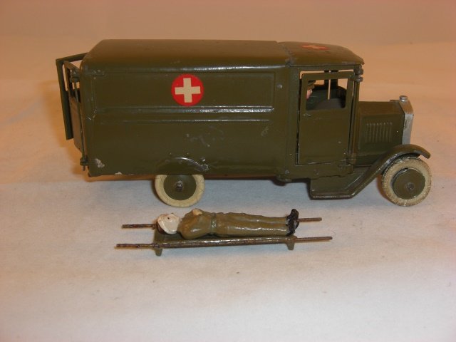 Britains #1512 Army Ambulance: Britains #1512 Army Ambulance; square front; with driver, stretcher, & wounded man; condition excellent; 4 pieces; pre war.