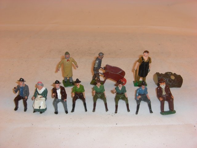 Britains Civilians: Britains civilians and 1 other figure; condition excellent; last figure on right and log non-Britains; 13 pieces; post war.