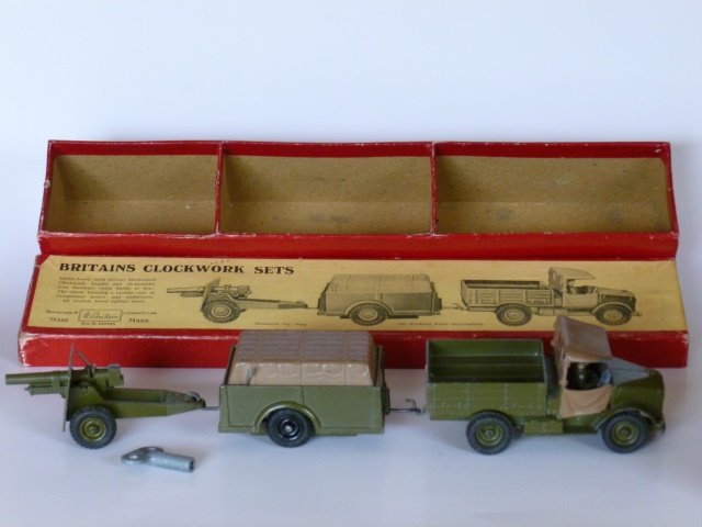 Britains Set #2048 Britains Clockwork Set: Beetle Lorry pulling trailer, pulling gun. Post War. 3 pieces, plus key and man inside truck. In original box. Condition excellent. Box very good.