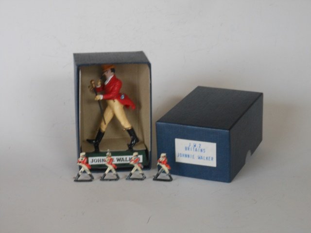 Britains Johnny Walker Assortment: Four miniature Talismen, Pre-War; and a Post War boxed plastic Johnny Walker. Condition very good. Box very good.