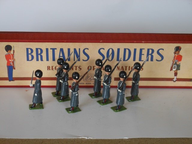 Britains Set #312 Grenadier Guards: Winter Dress. 8 pieces with original R.O.A.N. box. No tie card. Post War. Condition very good. Box very good.