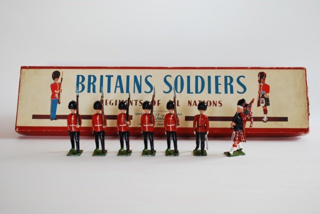 Britains Set #75 Scots Guards with Piper: Post War. 7 pieces, in original R.O.A.N. box. Untied. Condition very good. Box good. (but split 2 corners of lid.)