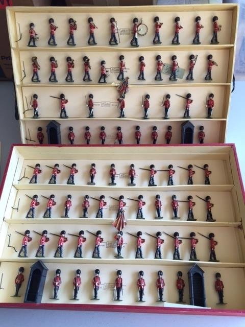 Britains Set #1555 Changing of the Guard: Post War. Originally tied in original box. A superior example of this 83 piece set with tin flags. Condition figures near mint. Condition box very good; with water marks on label. * There will be an a