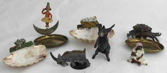 Heyde Souvenir Ashtrays: Pre War. Four ashtrays, one candle holder, donkey with nodding head and seated Arab. 7 pieces. Condition figures very good.