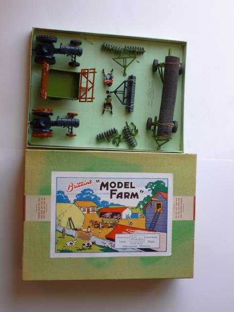 Britains VERY RARE Farm Set #134F: containing 2 tractors and various farm machinery. Secured in lift off lid box. Post War. 7 pieces. Condition very good. Box very good. (one farrow damaged)