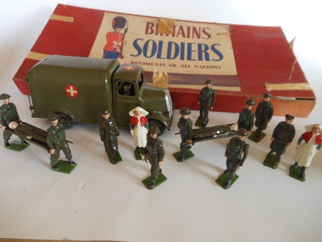 Britains RARE Set #1897 Medical Display: Post War. 11 pieces. Ambulance, stretcher parties, nurses, doctors, and rare female ambulance drivers. Condition of figures very good. Box poor (with split ends and tape.)