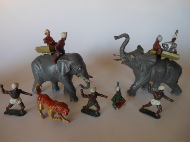 Timpo from the Tiger Hunt Set: 2 elephants, 2 Mahouts, 2 Howdahs, Maharajas, one white hunter, 3 Indian Beaters, and a Crescent Tiger. Total of 13 pieces. Unboxed. Post War. Condition very good. But the white hunter has been repain