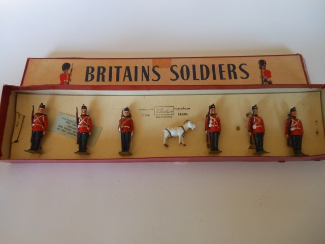 Britains Set #2148 Fort Henry Guards with Mascot: Post War. 7 pieces tied in original R.O.A.N. box. Condition very good. Box. Very good.