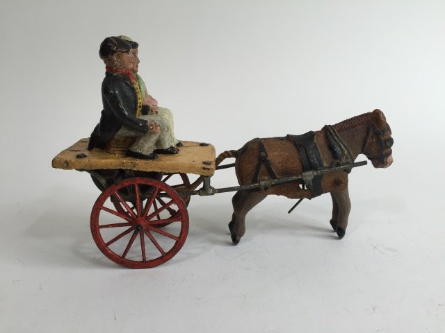 Britains Mechanical Galloping Donkey Cart: Circa 1883. One of the earliest examples of Britains production. This gyroscopic toy propels the donkey to gallop in a realistic fashion. Very rare with beautiful detailing to face. 1 Piece. Condition
